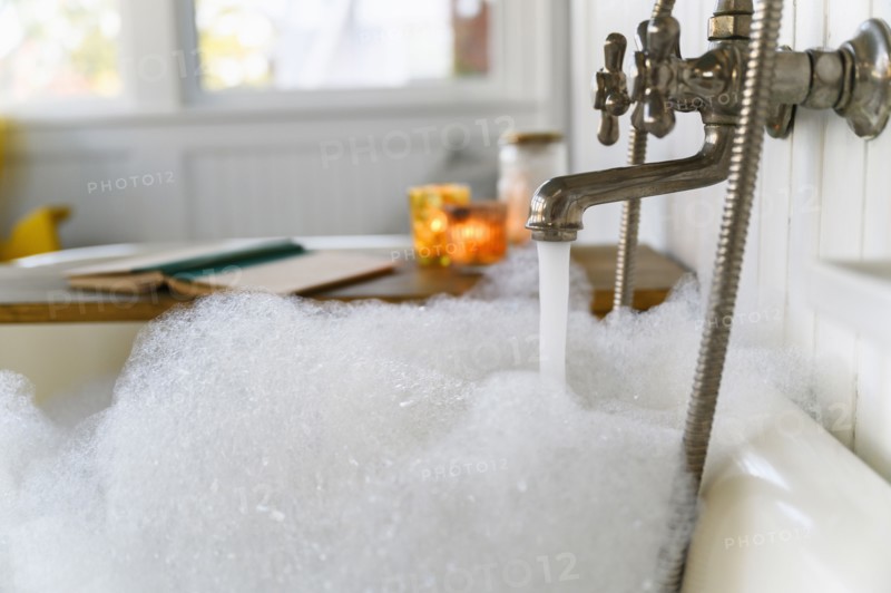 Bubble bath with book and candles