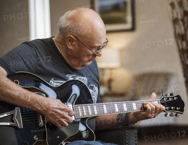 Senior man playing guitar