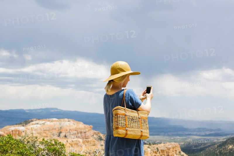 USA, Utah, Bryce Canyon, Woman photographing canyon with smart phone