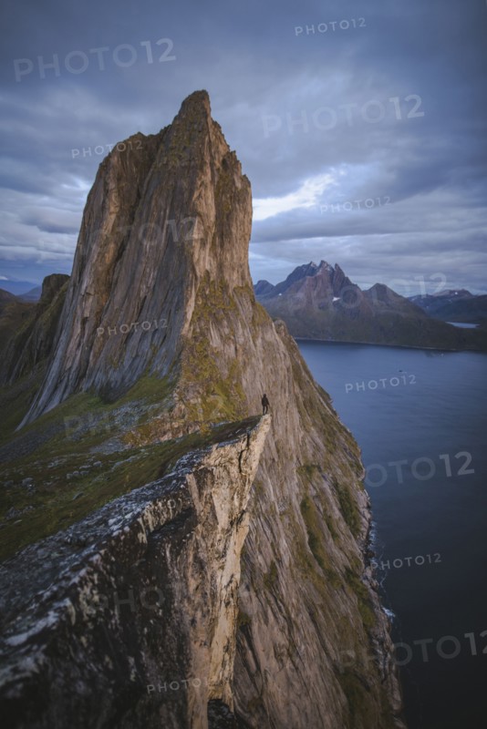 Norway, Senja, Man standing on cliff edge near Segla mountain