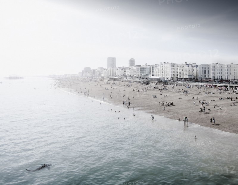 England, Brighton, People resting at urban beach