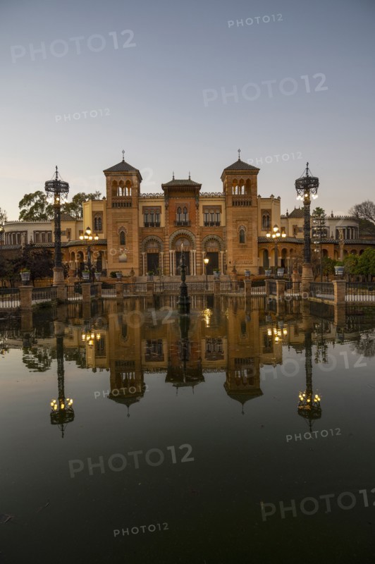 Spain, Seville, Museum of Arts and Popular Customs of Seville reflecting in pond