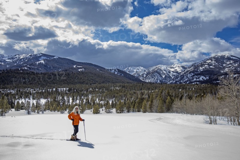 USA, Idaho, Sun Valley, Woman snowshoeing in winter landscape