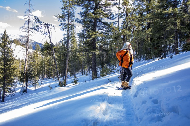 USA, Idaho, Sun Valley, Woman snowshoeing in winter landscape