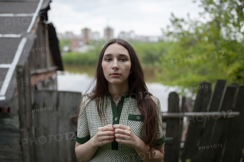 Russia, Omsk, Portrait of young woman in backyard