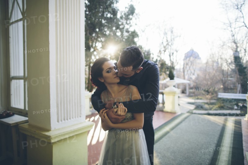 Newlywed couple embracing at terrace