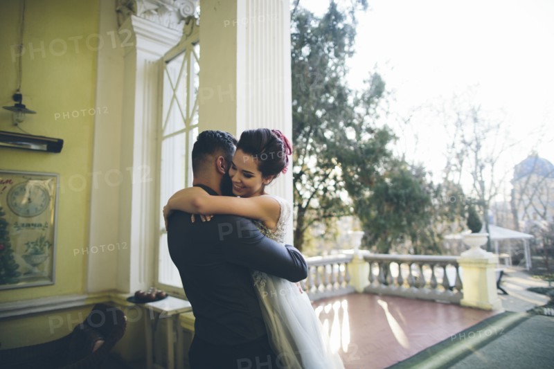 Newlywed couple embracing at terrace