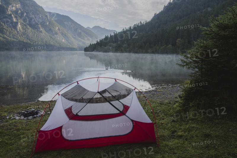 Austria, Plansee, Tent by lake Plansee in Austrian Alps at sunrise