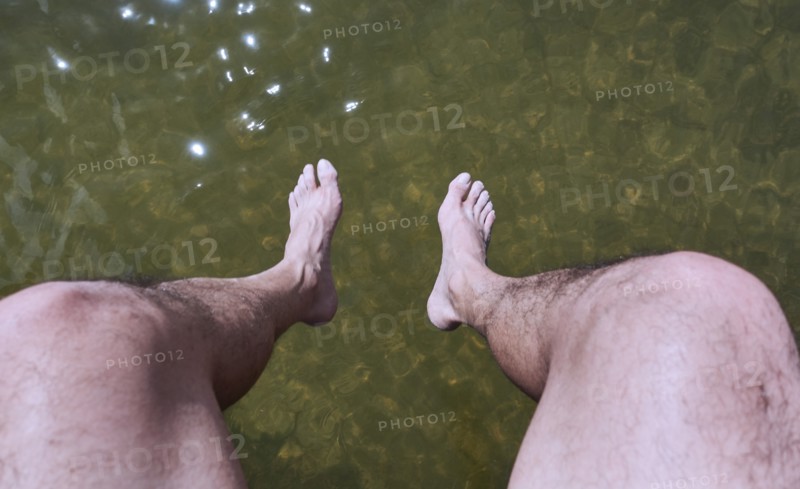 Man sitting above water