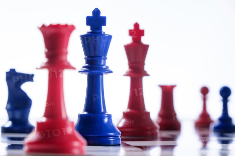 Studio shot of red and blue chess pawns symbolizing US Democratic and Republican parties