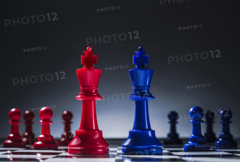 Studio shot of red and blue chess pawns symbolizing US Democratic and Republican parties