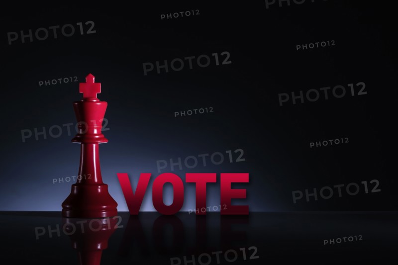 Studio shot of red chess king with word Vote