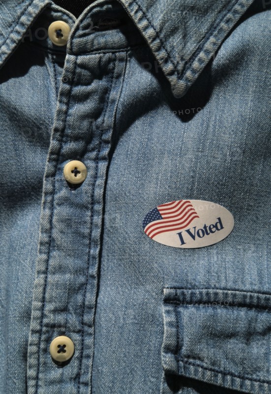 Close-up of I voted sticker on denim shirt