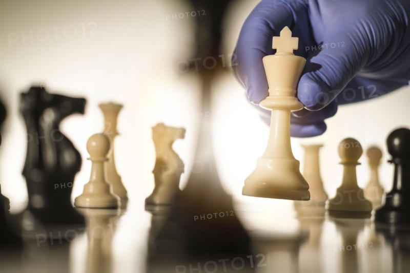 Chess king in gloved hand