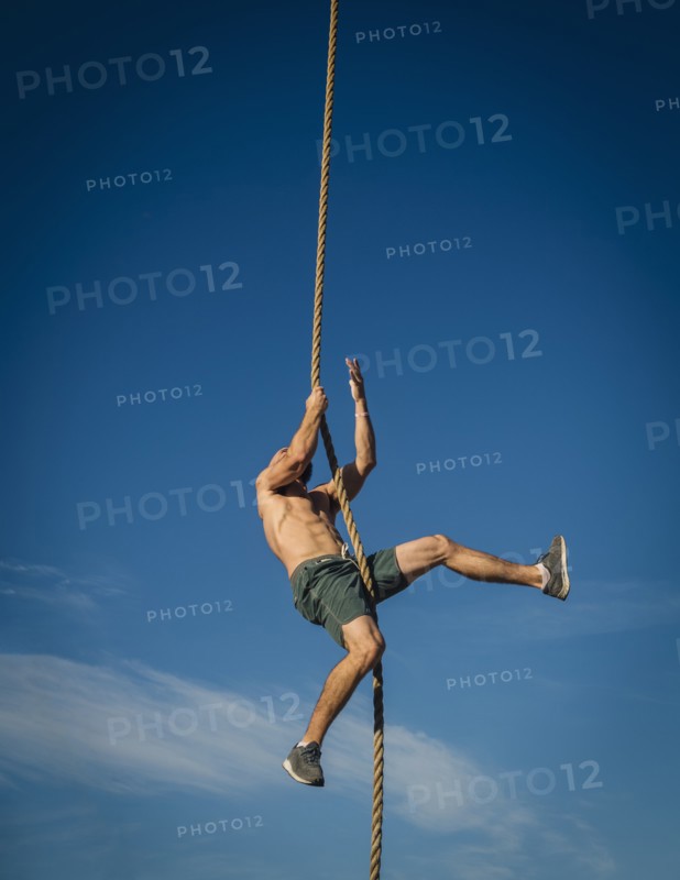 Man climbing on rope