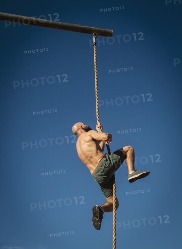 Man climbing on rope