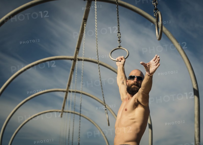Man exercising on gymnastics rings