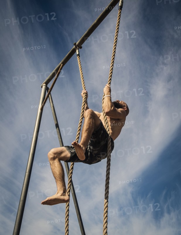 Man exercising on rope