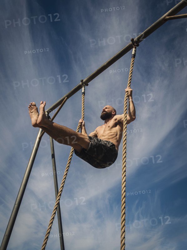 Man exercising on rope