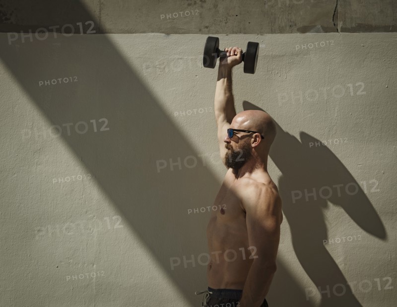 Man exercising with dumbbell