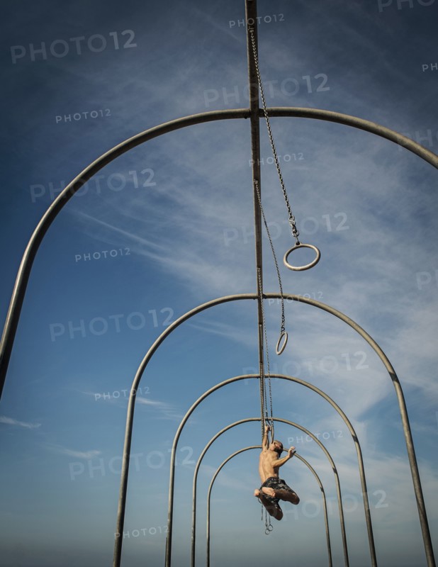 Man exercising on gymnastics rings