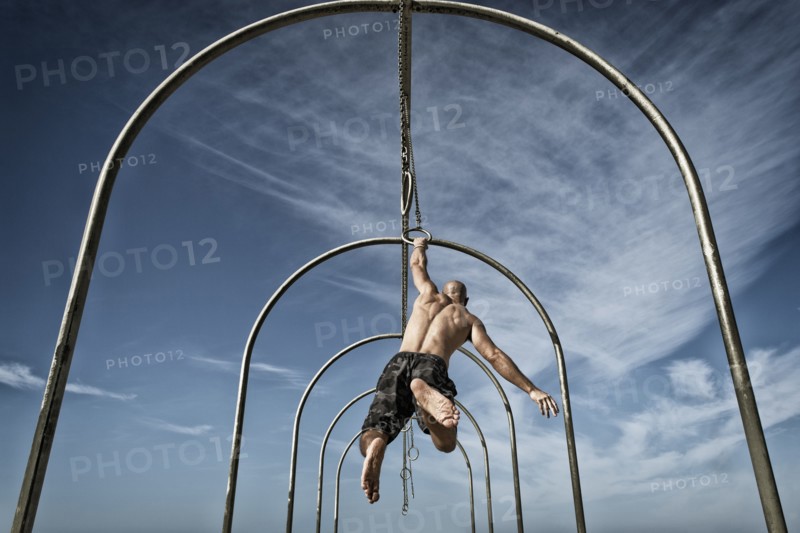 Man exercising on gymnastics rings