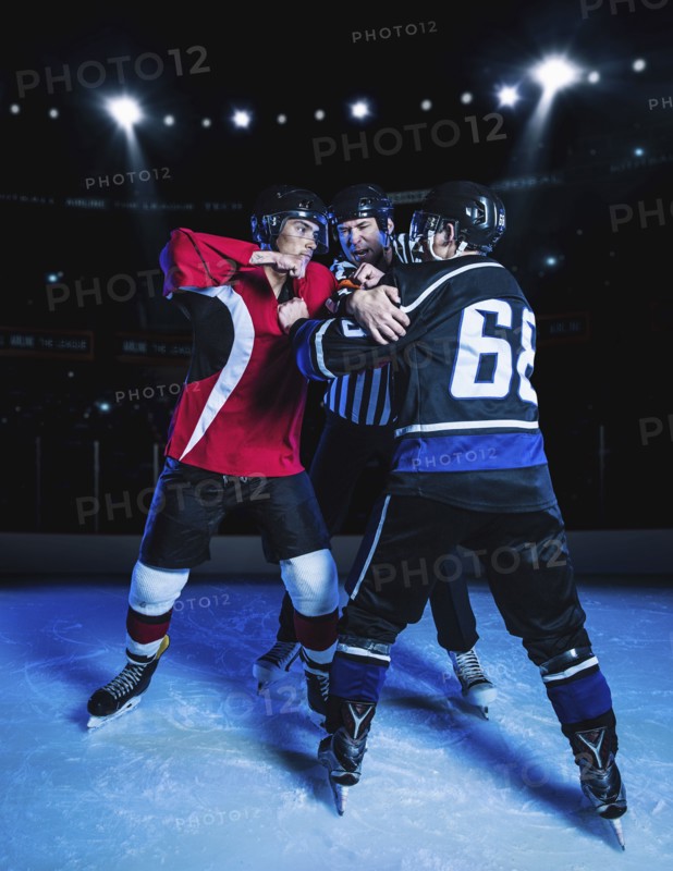 Referee separating fighting hockey players