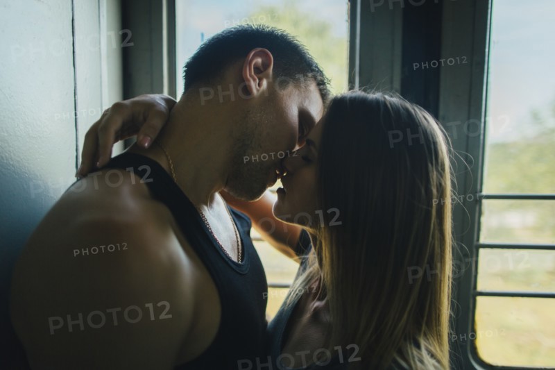 Couple kissing on train