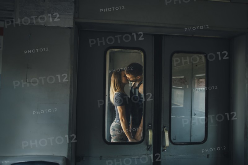 Couple kissing on train