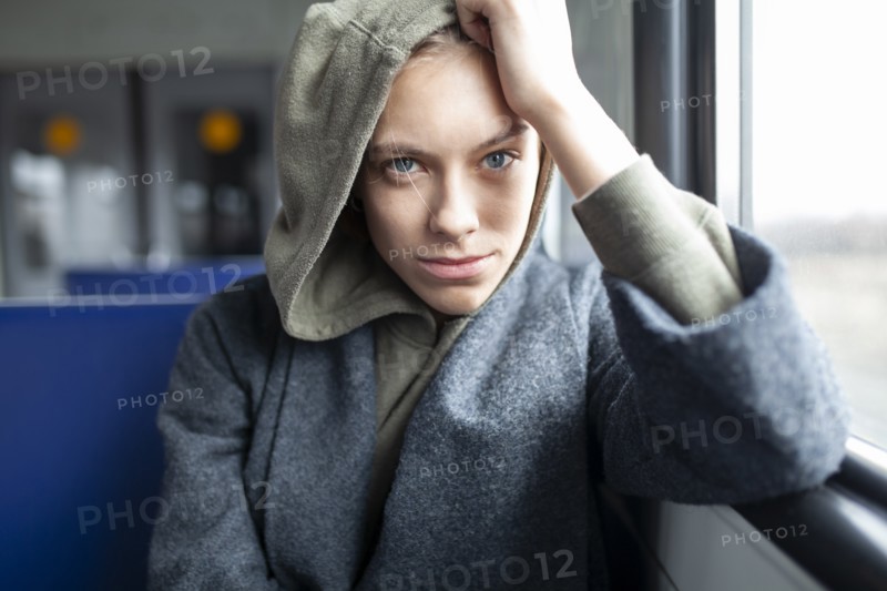 Portrait of young woman in train