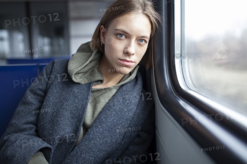 Portrait of young woman in train