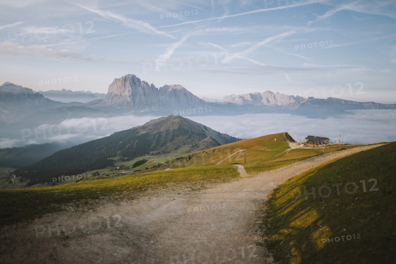 Italy, Dolomite Alps, Scenic view of small village in Dolomites at sunrise