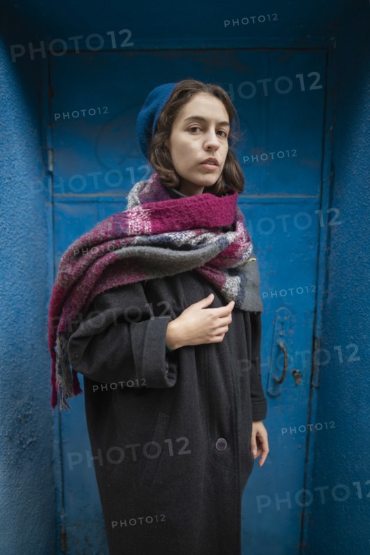 Portrait of young woman wearing coat, beret and scarf,