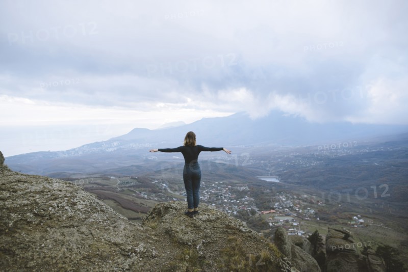 Ukraine, Crimea, Young woman looking at valley in Crimea mountains