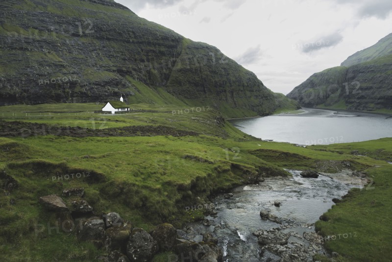Denmark, Small church in green landscape with mountains,