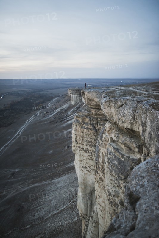 Ukraine, Crimea, Hiker on edge of steep cliff near White Mountain