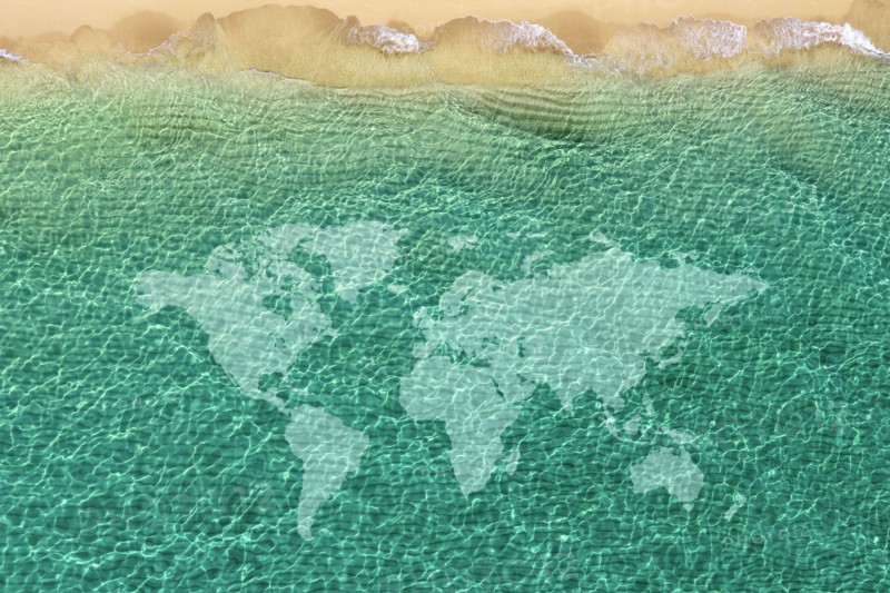 World map against beach wave,,