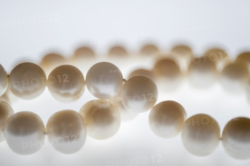 Close up of pearl necklace on white