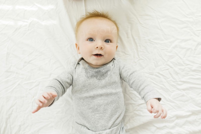 Portrait of baby boy lying on bed