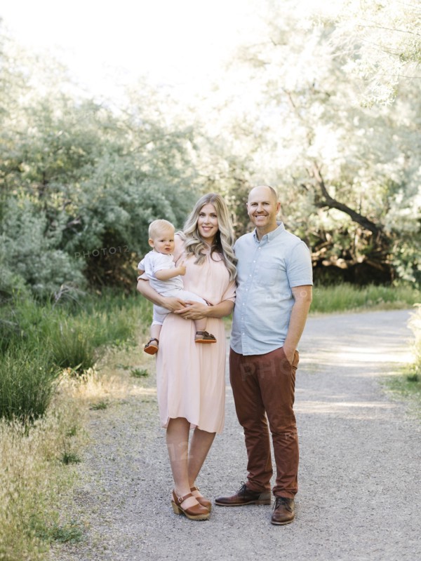 Family with baby boy (12-17 months) standing in park