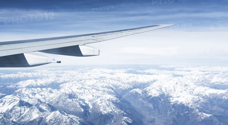 Switzerland, Canton Wallis, Airplane wing over snowy mountains