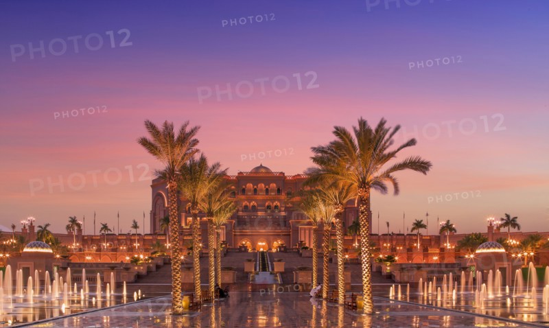 United Arab Emirates, Abu Dhabi, Palm trees and fountain in front of Hotel Emirates Palace