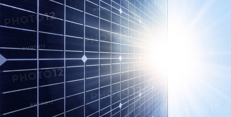 Sun shining over solar panel