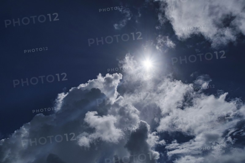 White clouds and sun on blue sky