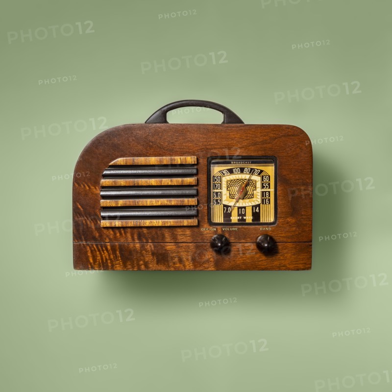 Retro wooden radio on green background