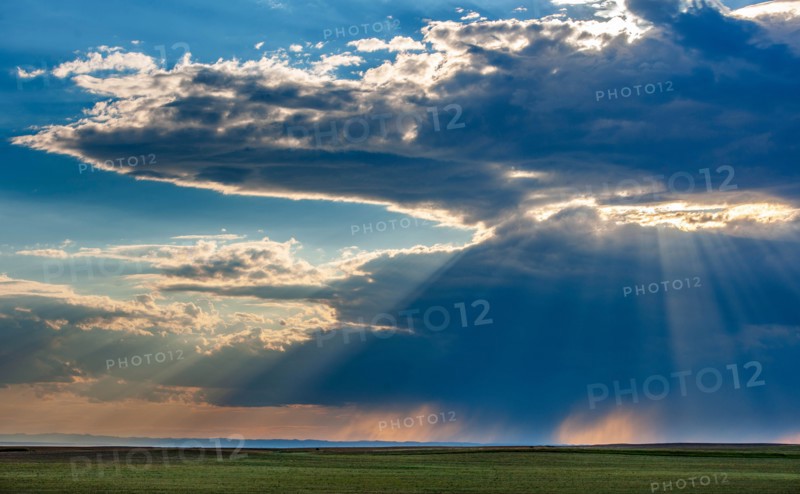 USA, South Dakota, Storm clouds at sunset over prairie