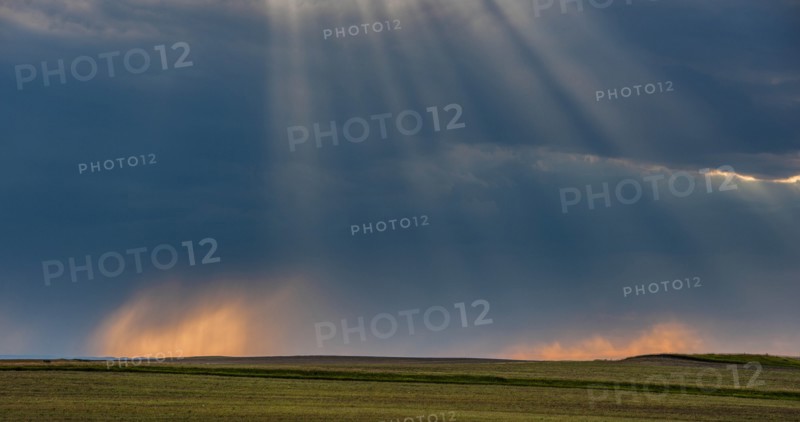 USA, South Dakota, Storm clouds at sunset over prairie