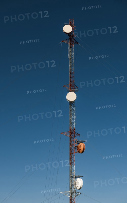 Communication tower against blue sky