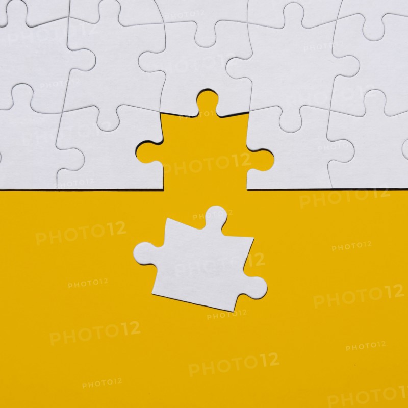 Last puzzle piece in jigsaw puzzle on yellow background