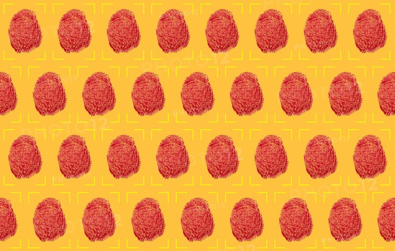 Red fingerprints on yellow background